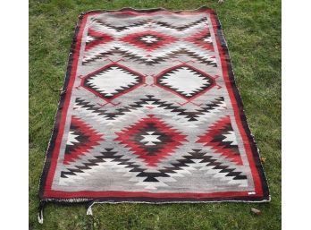 An antique Navajo rug with geometric