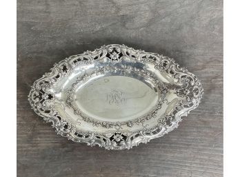 A silver bread tray with highly decorative