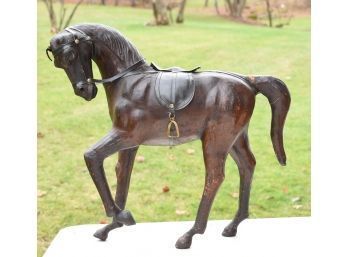 A vintage leather horse figure.