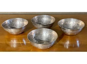 Four unmarked silver bowls with