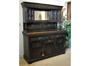 An antique two-part ebonized sideboard.