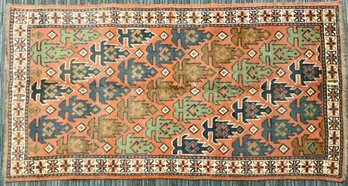 A vintage scatter rug with burnt 3aa5b0