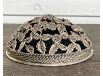 A sterling repousse hat pin cushion