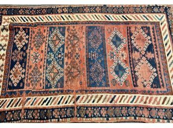 An antique oriental scatter rug