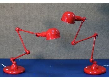 A pair of red painted steel adjustable