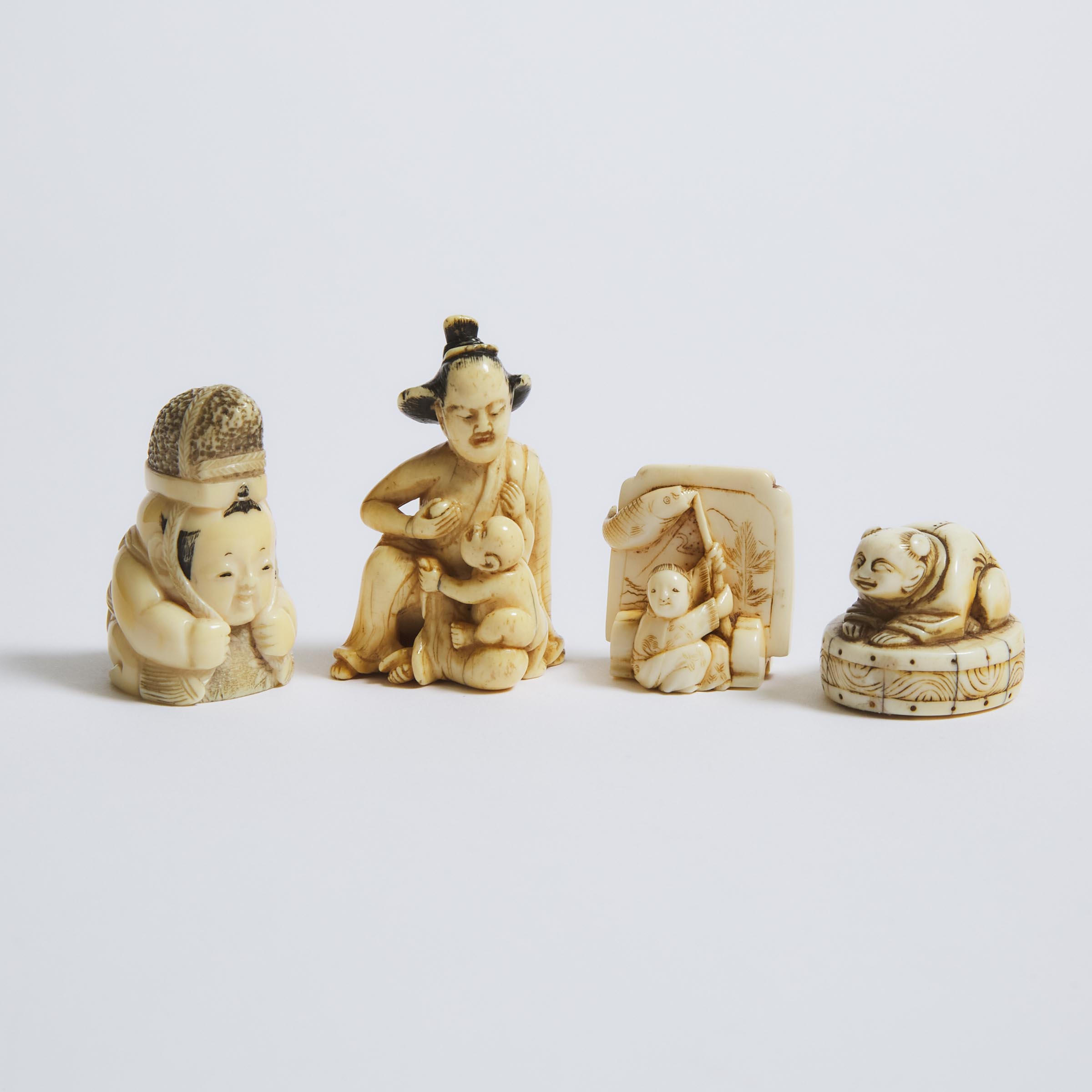 An Ivory Netsuke of a Mother and