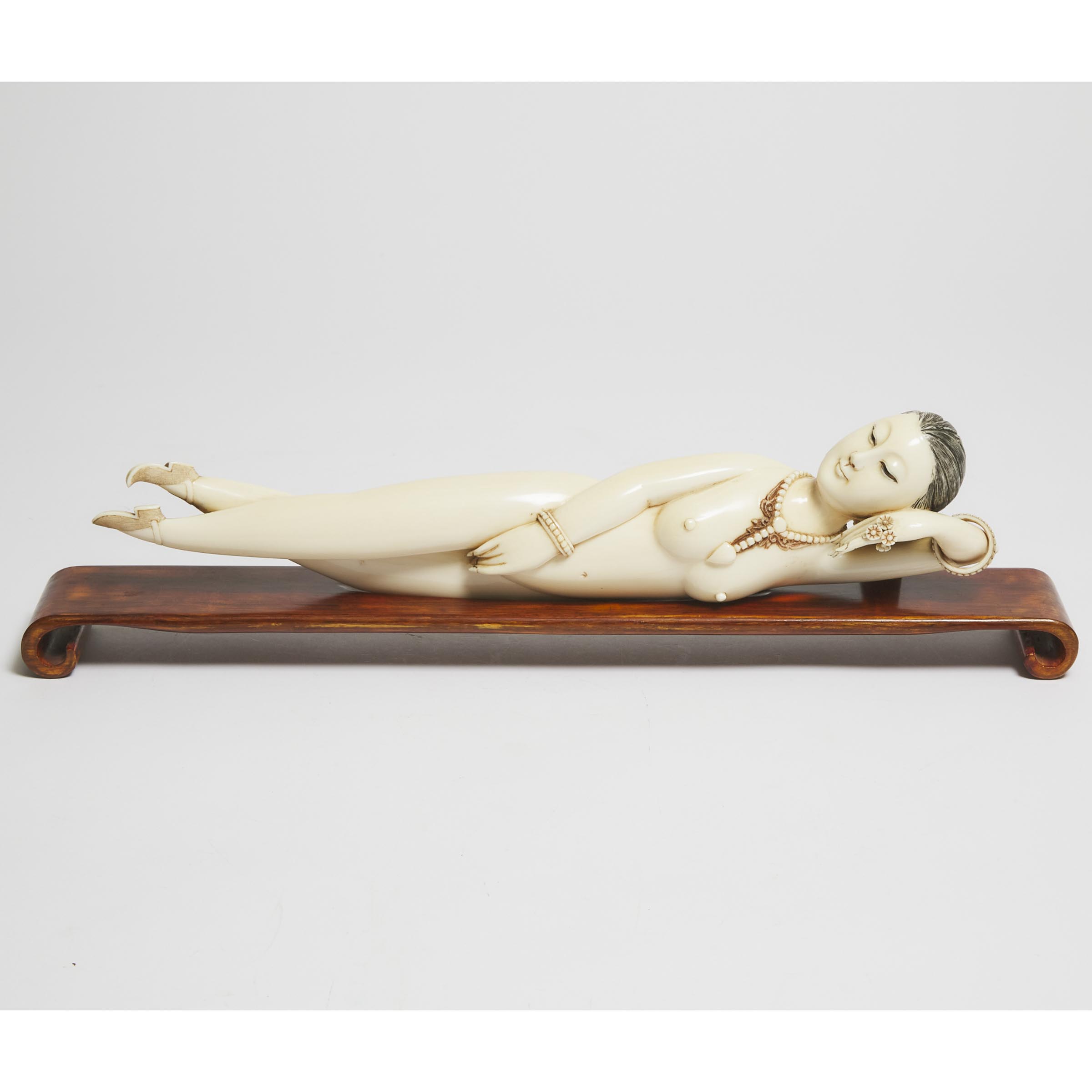 A Large Ivory Figure of a Reclining