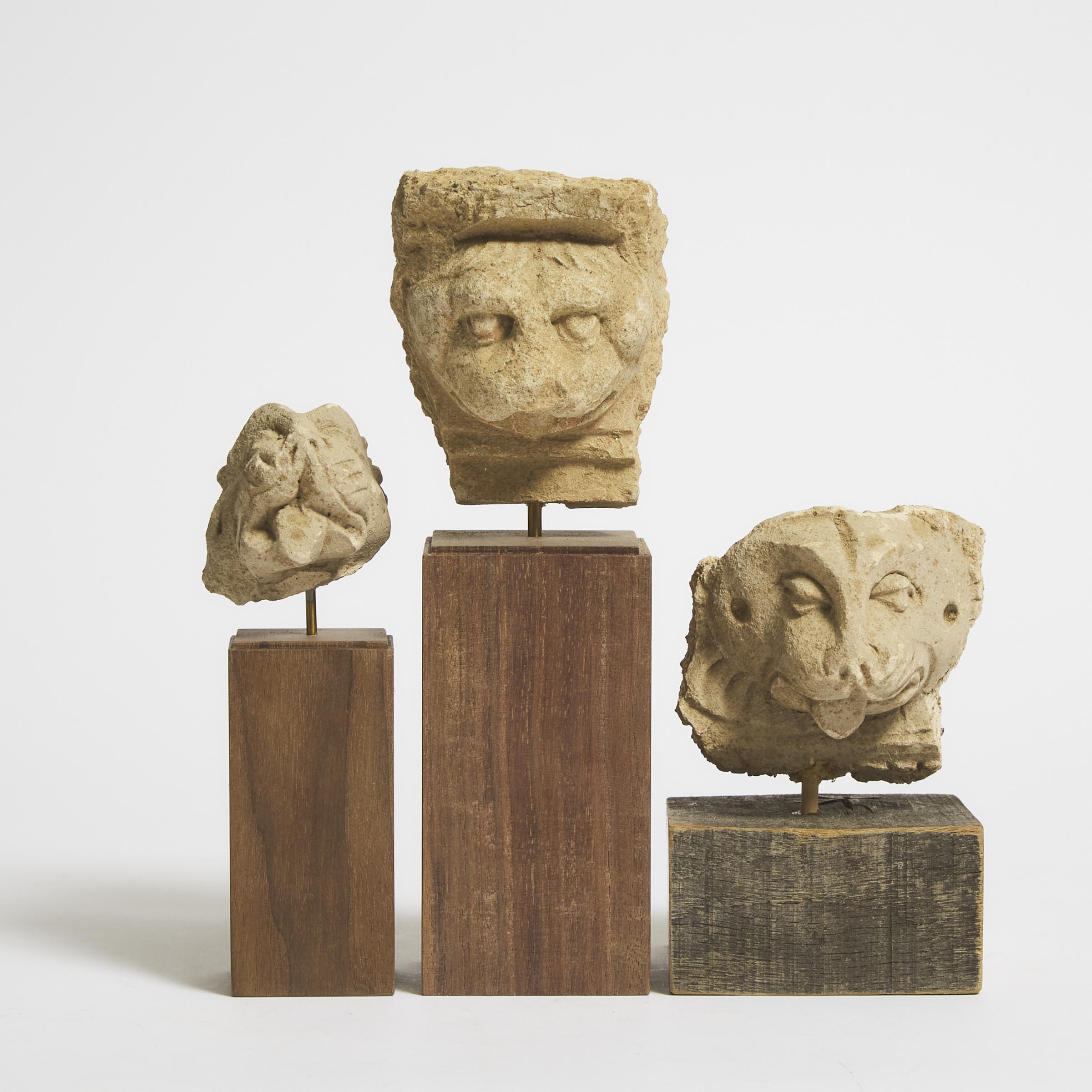 A Group of Three Stucco Lion Heads,