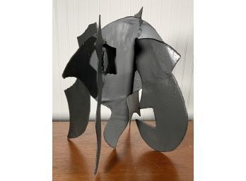 A black painted abstract steel sculpture,
