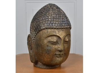 An early carved stone head with applied