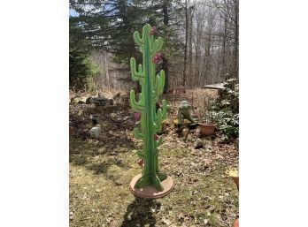 A paint decorated cut wood cactus