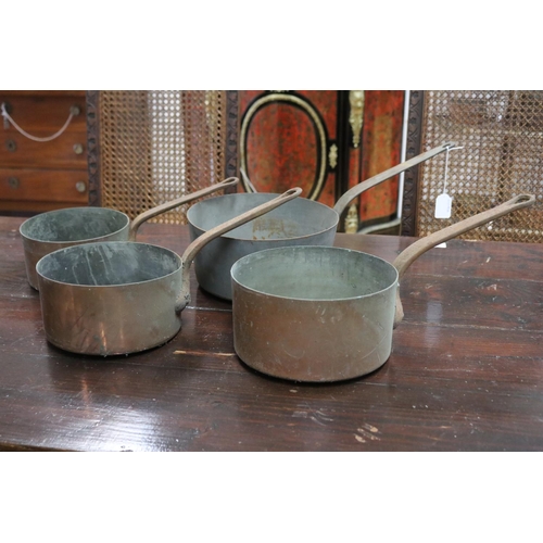 Four antique copper saucepans,