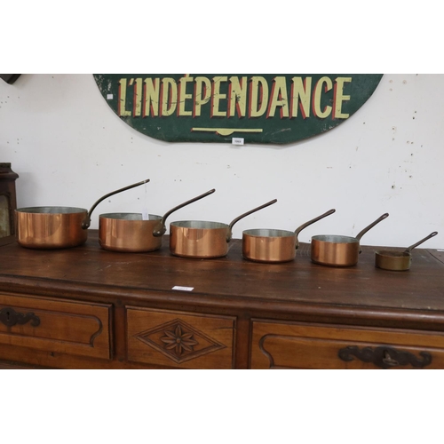 Set of six French copper saucepans,