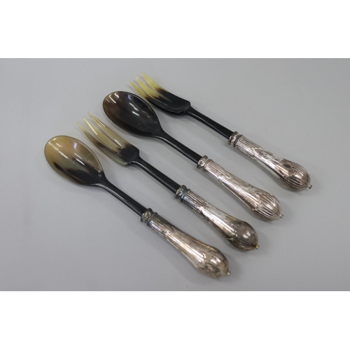 Two pairs of horn salad servers, each