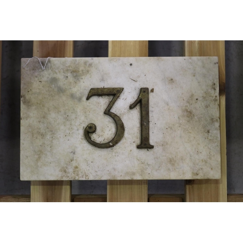 Marble plaque wit the number 31