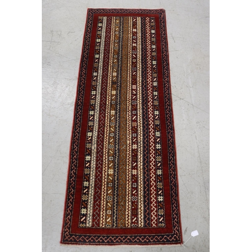 Handwoven red ground hall carpet,