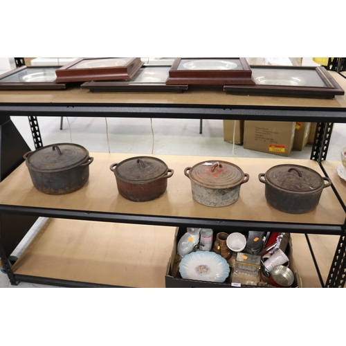 Set of four iron lidded pots (4)