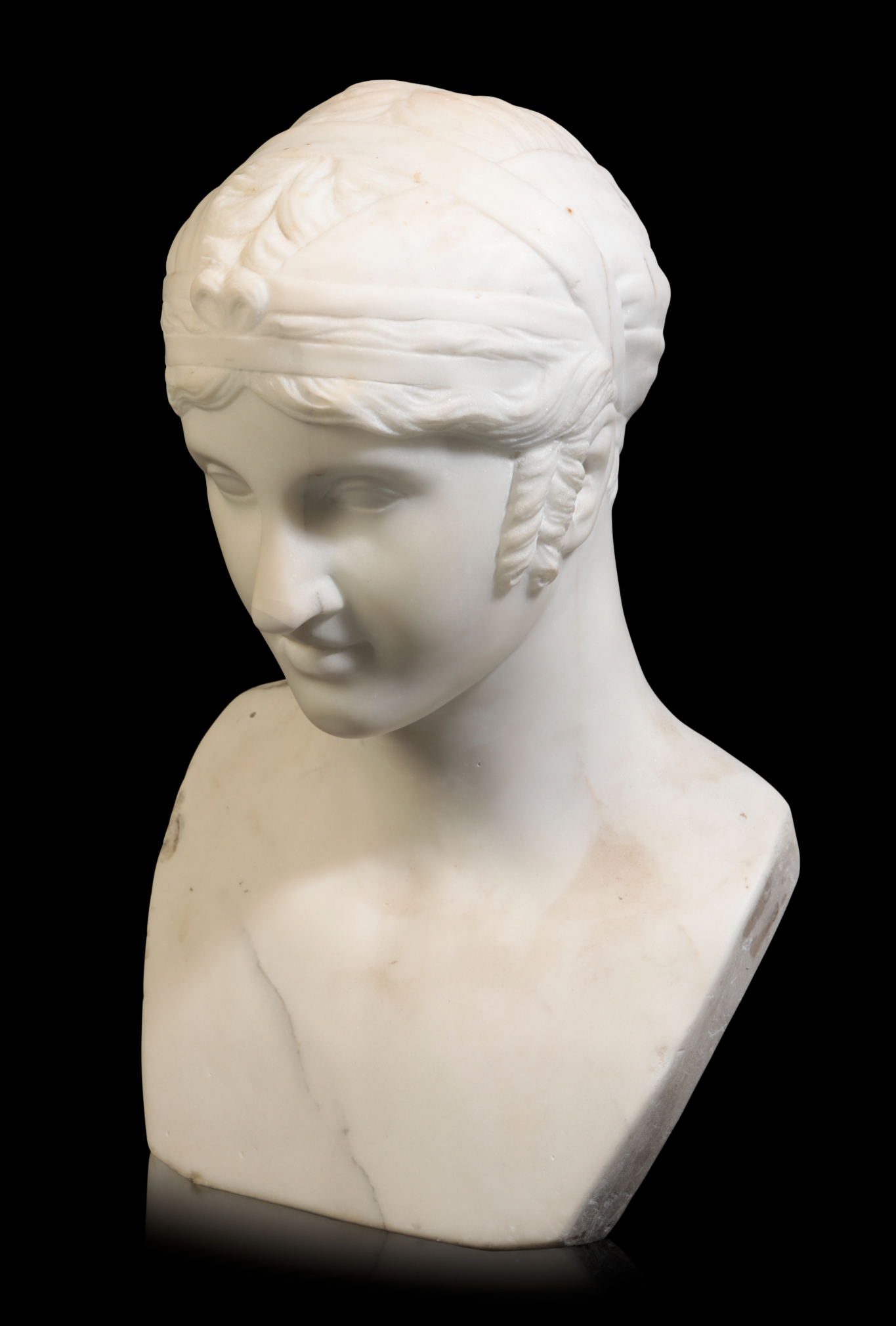 A WHITE MARBLE BUST OF A YOUTH carved