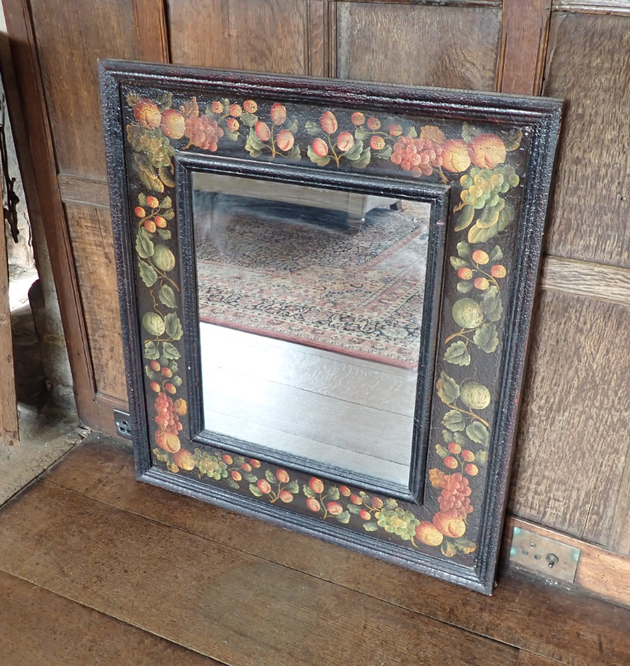 AN EBONISED WOOD RECTANGULAR MIRROR