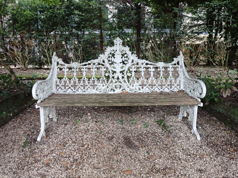 A CAST METAL GARDEN BENCH of naturalistic