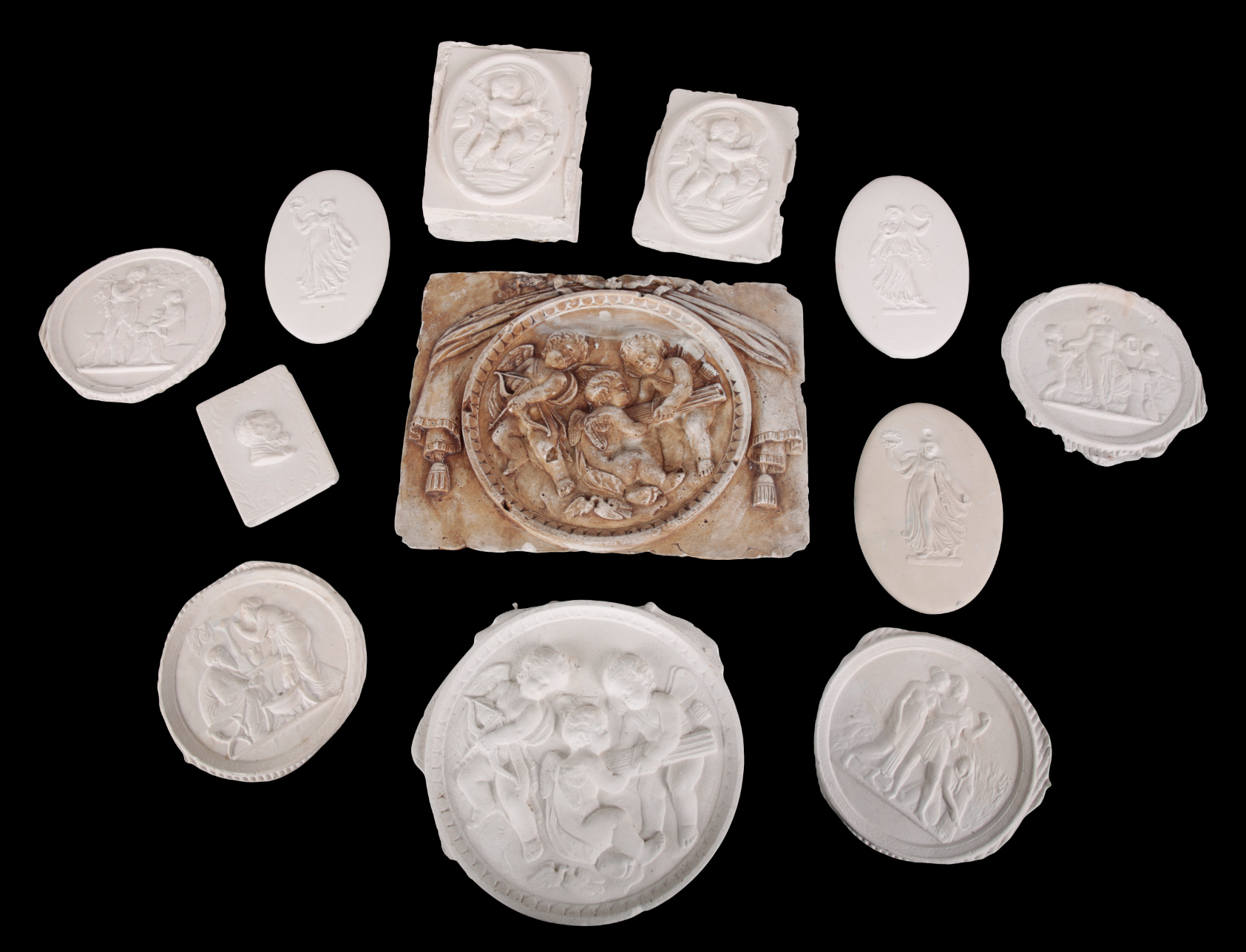 A GROUP OF TWELVE PLASTER ROUNDELS