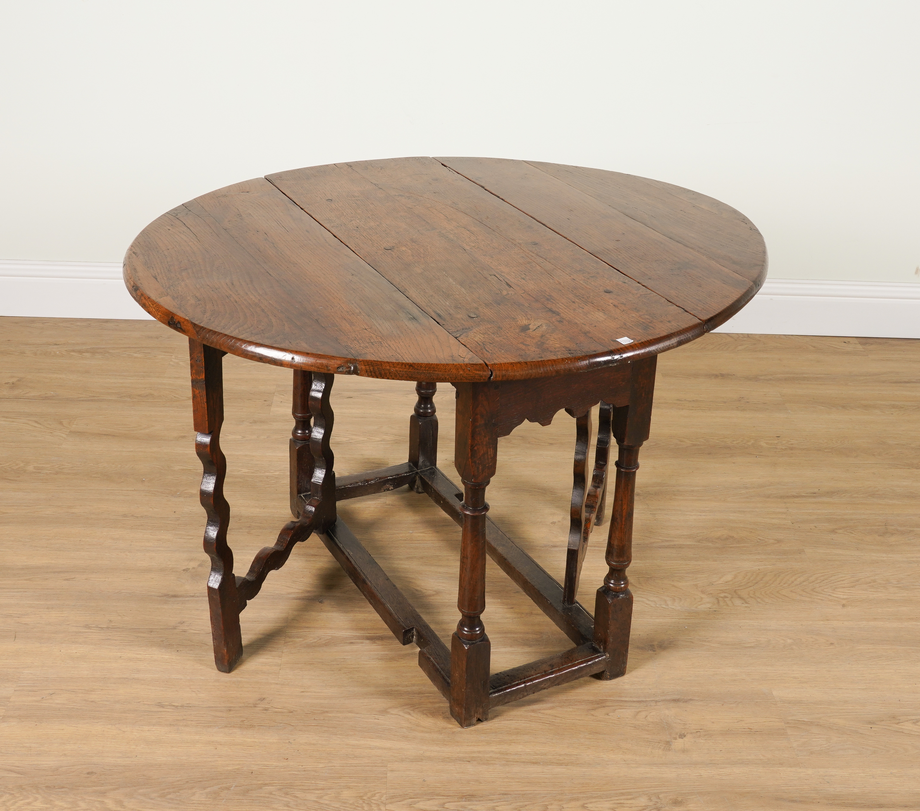 A 17TH CENTURY OAK DROP-LEAF TABLE