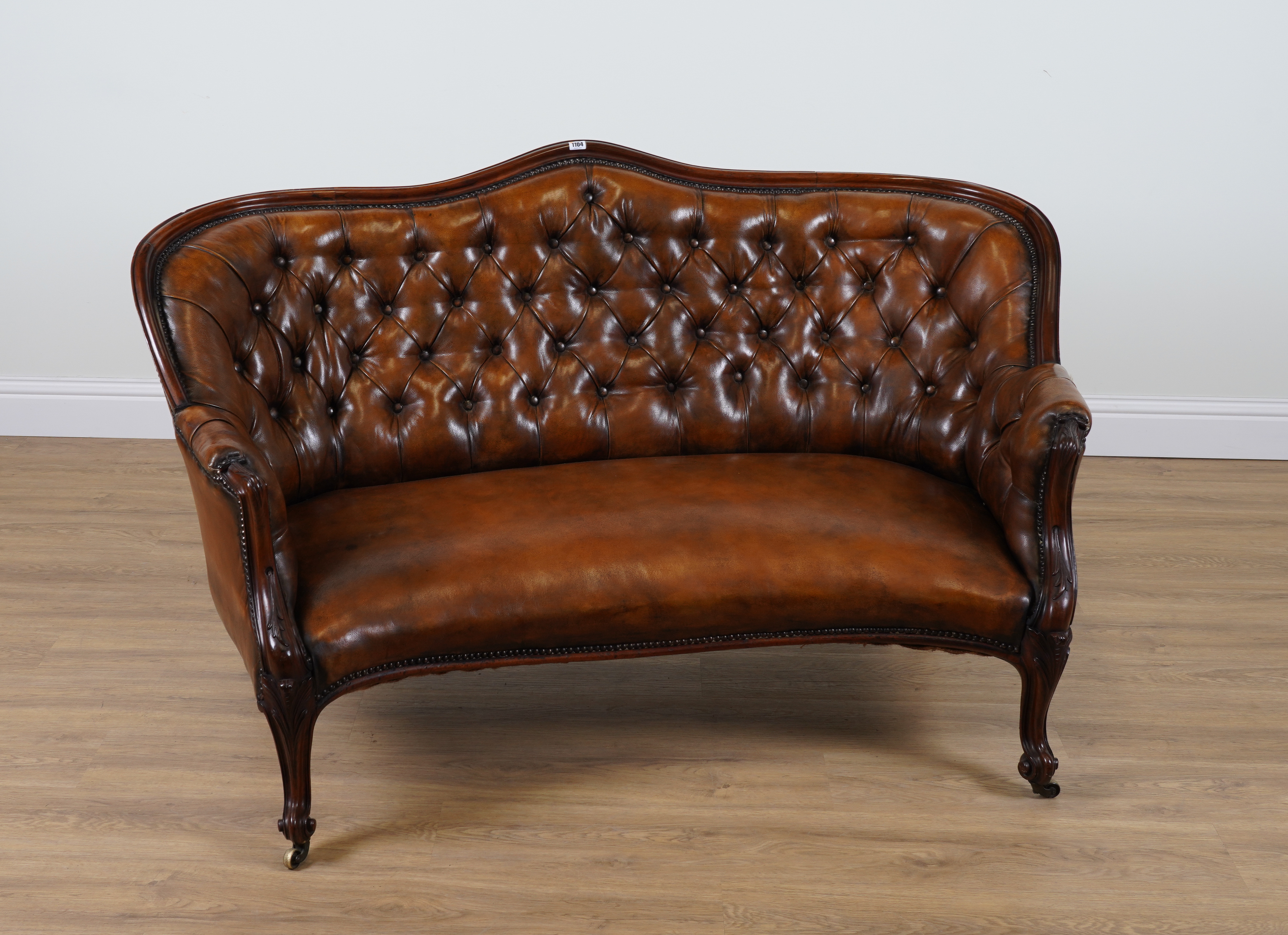 A 19TH CENTURY TAN LEATHER UPHOLSTERED