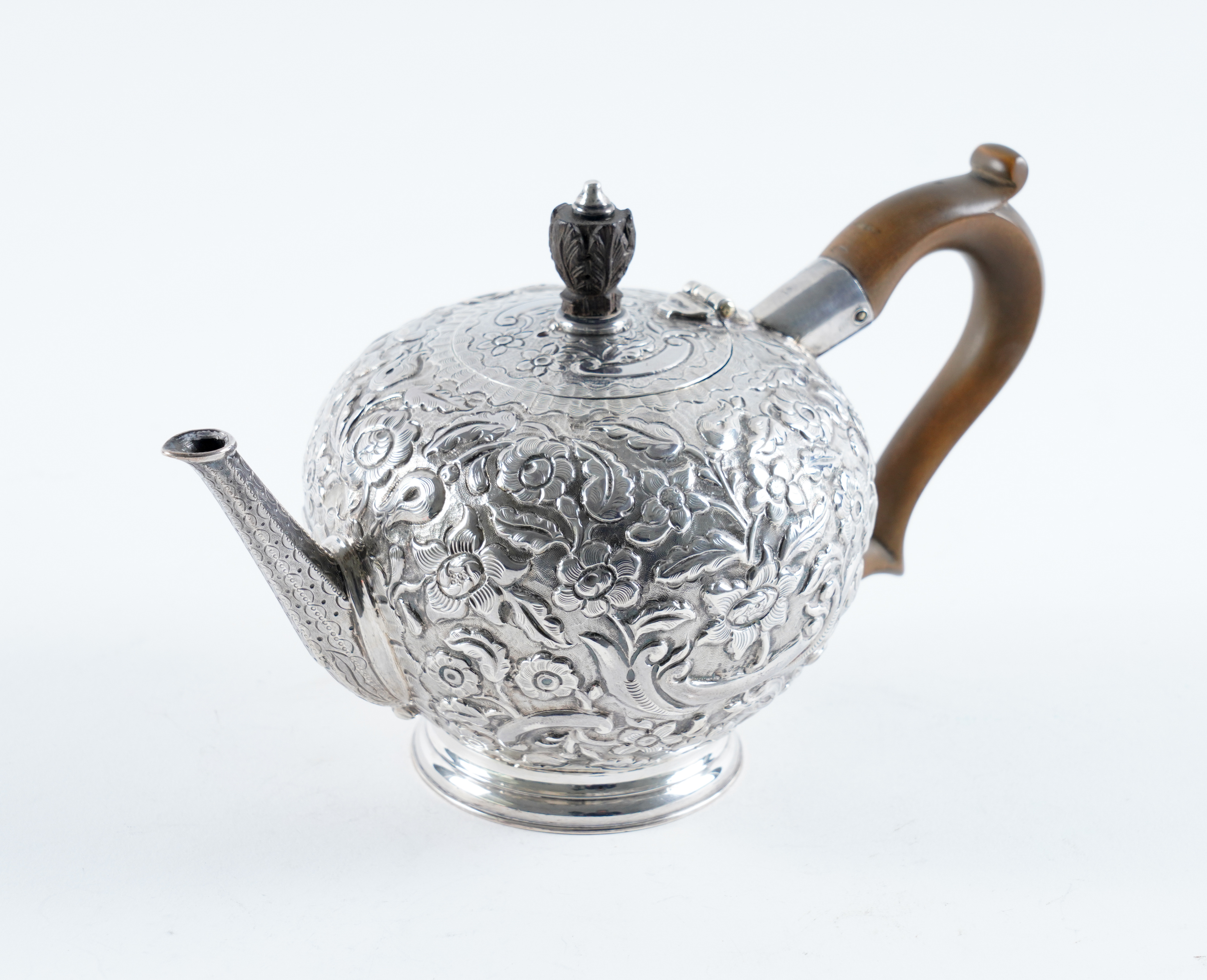 A GEORGE I SILVER TEAPOT Of compressed