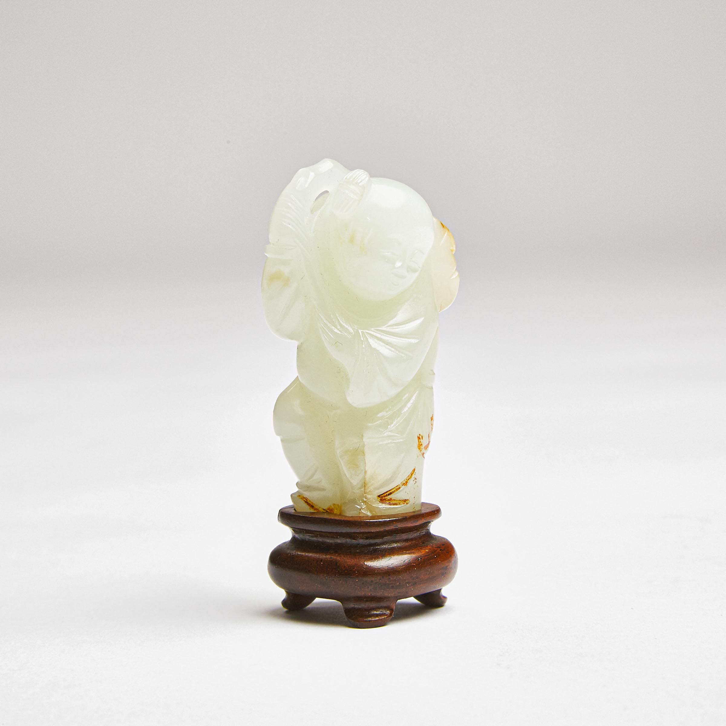 A White Jade Figure of a Boy Holding