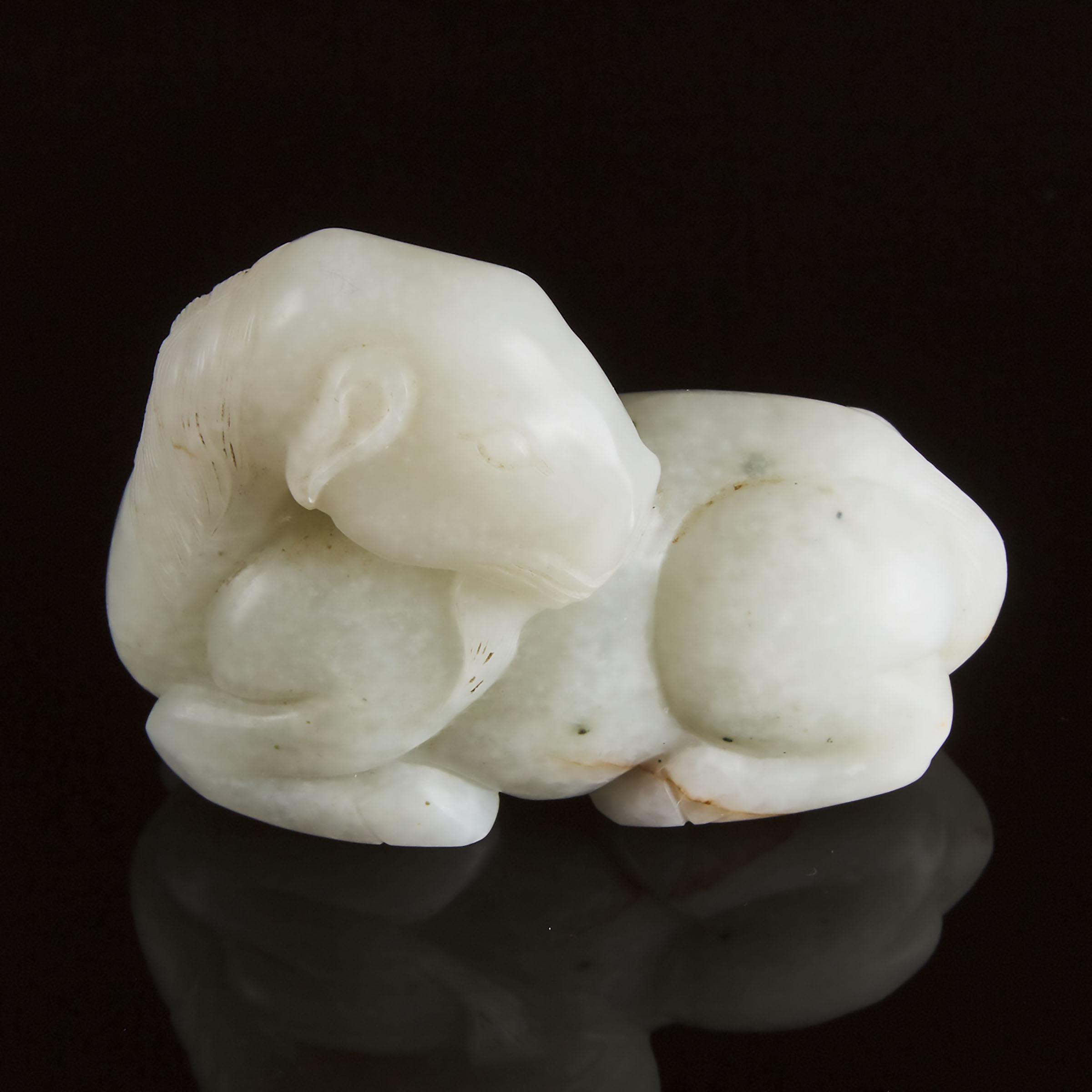 A Mottled White Jade Carving of a Recumbent