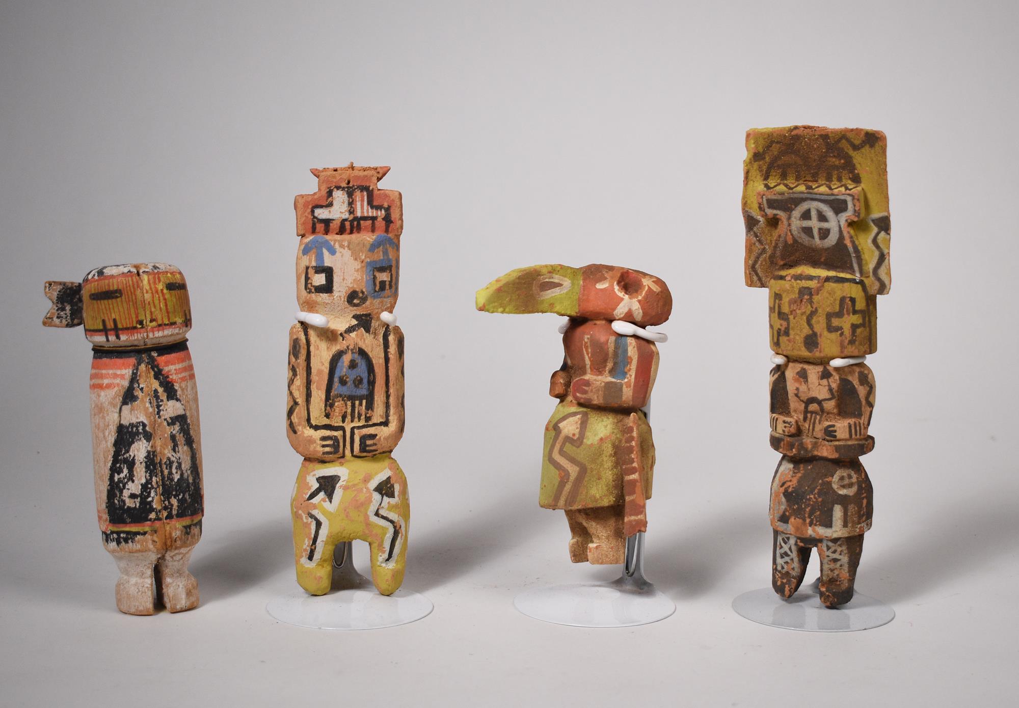 FOUR CARVED AND PAINTED KACHINA DOLLS.