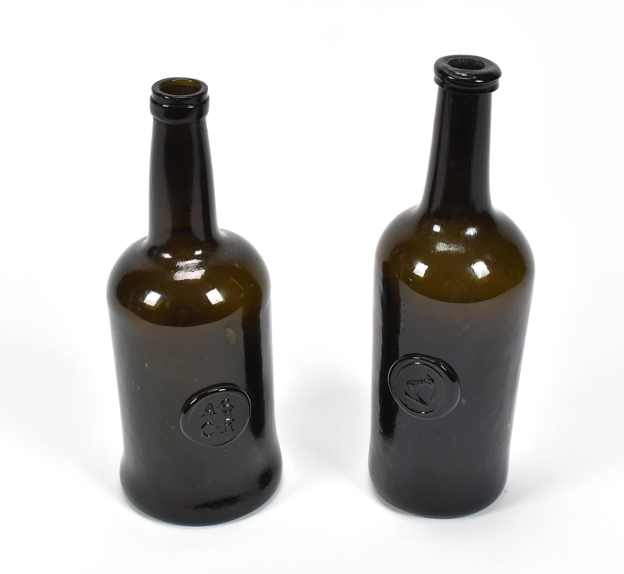 TWO 18TH C BLACK GLASS SEAL BOTTLES.