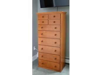 A cherry tall chest of drawers,