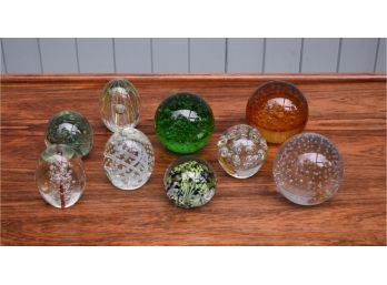 Nine various paperweights with controlled