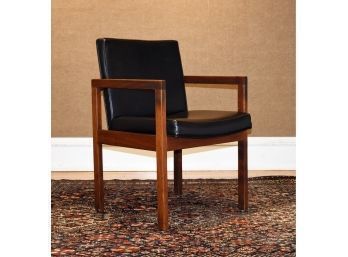 A vintage teak arm chair with synthetic