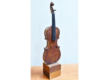 A vintage violin mounted on end,