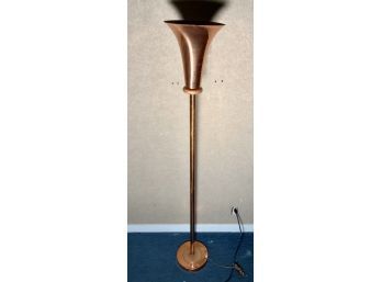 A vintage copper floor lamp with