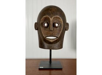 A carved African wooden mask on