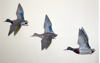 Three painted carved pine flying
