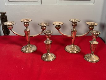 Four weighted sterling candlesticks,