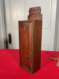 An antique dovetailed candle box