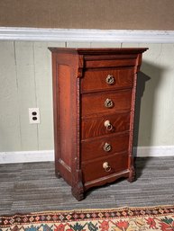 A ca. 1900 narrow, oak five drawer chest