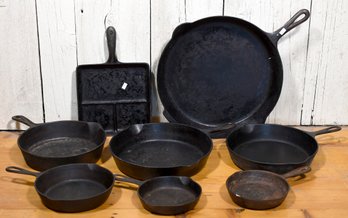 Eight vintage cast iron skillets  3b00ea