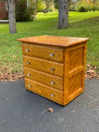 A vintage birdseye maple four drawer