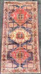 A vintage Oriental rug, alternating