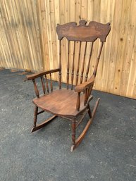 A vintage rocking chair with a floral