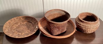 Four vintage woven baskets, including;