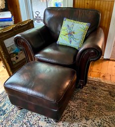 A dark brown leather club chair 3b02b0