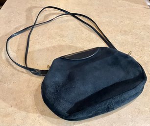 A purse with a black suede body 3b02c5