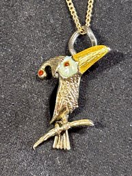 A 14K gold Toucan pendant on a